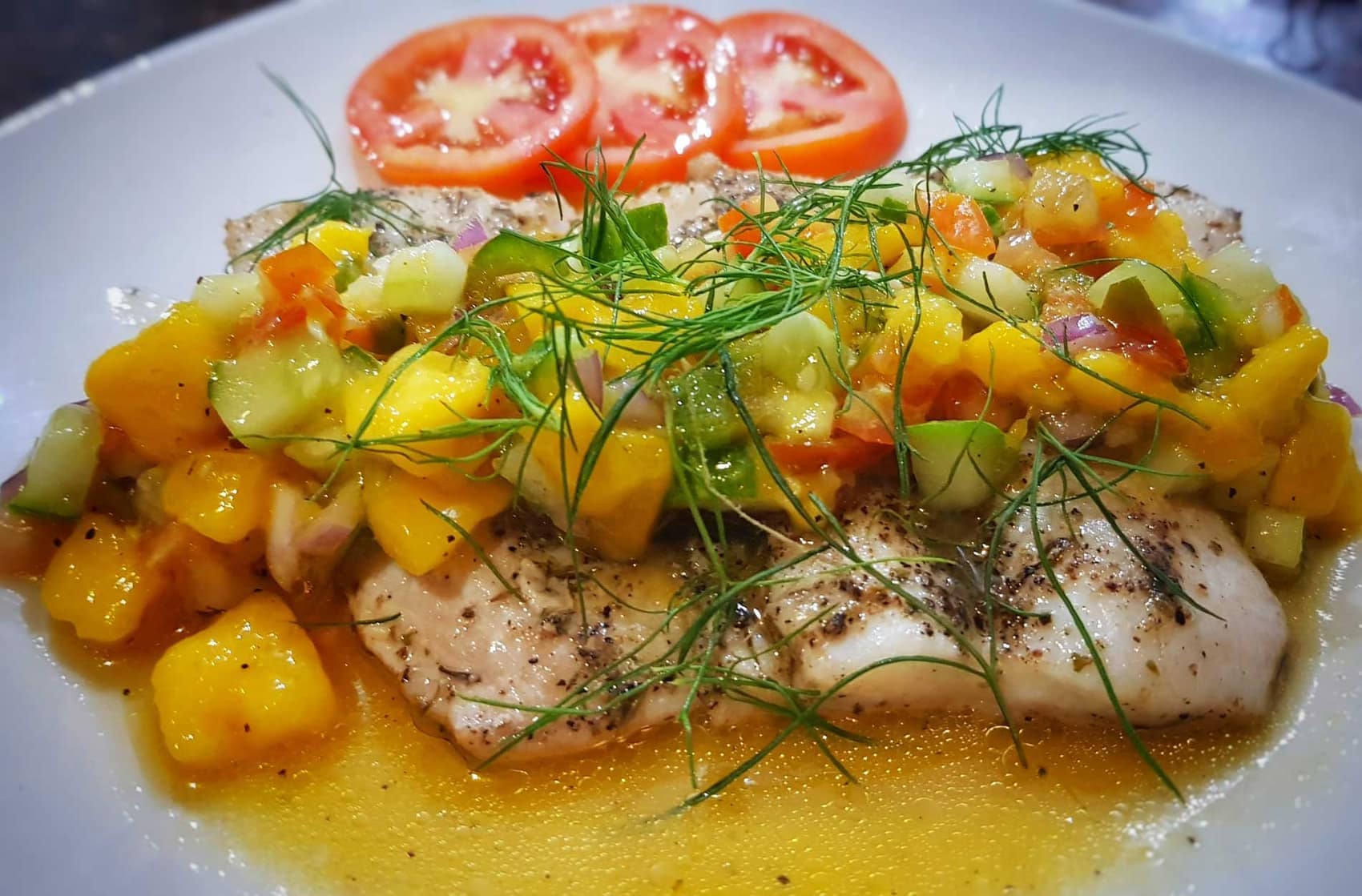 Fish Fillet with Mango Salsa, dressed with fennel and fresh tomato