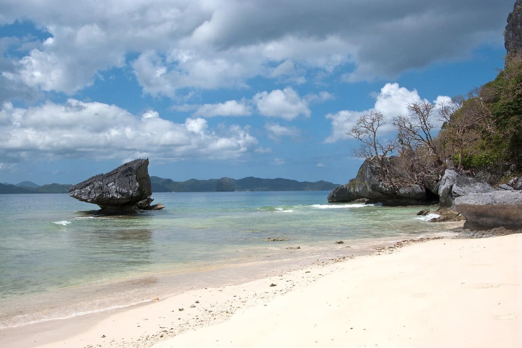 White sand and a lone rock at Corong-Corong, ten minutes south of town