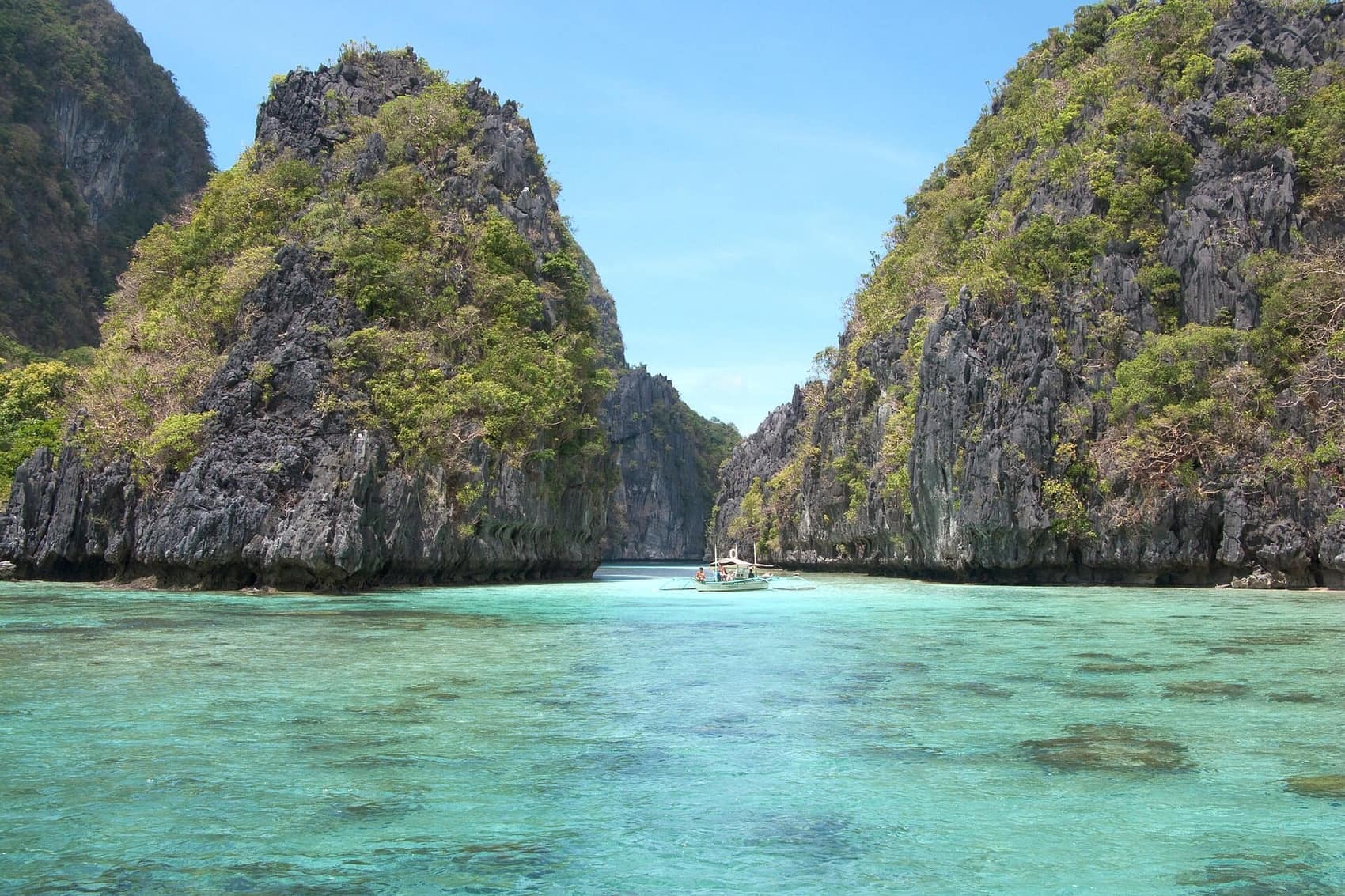 Sheer karst walls dropping into a hidden island lagoon