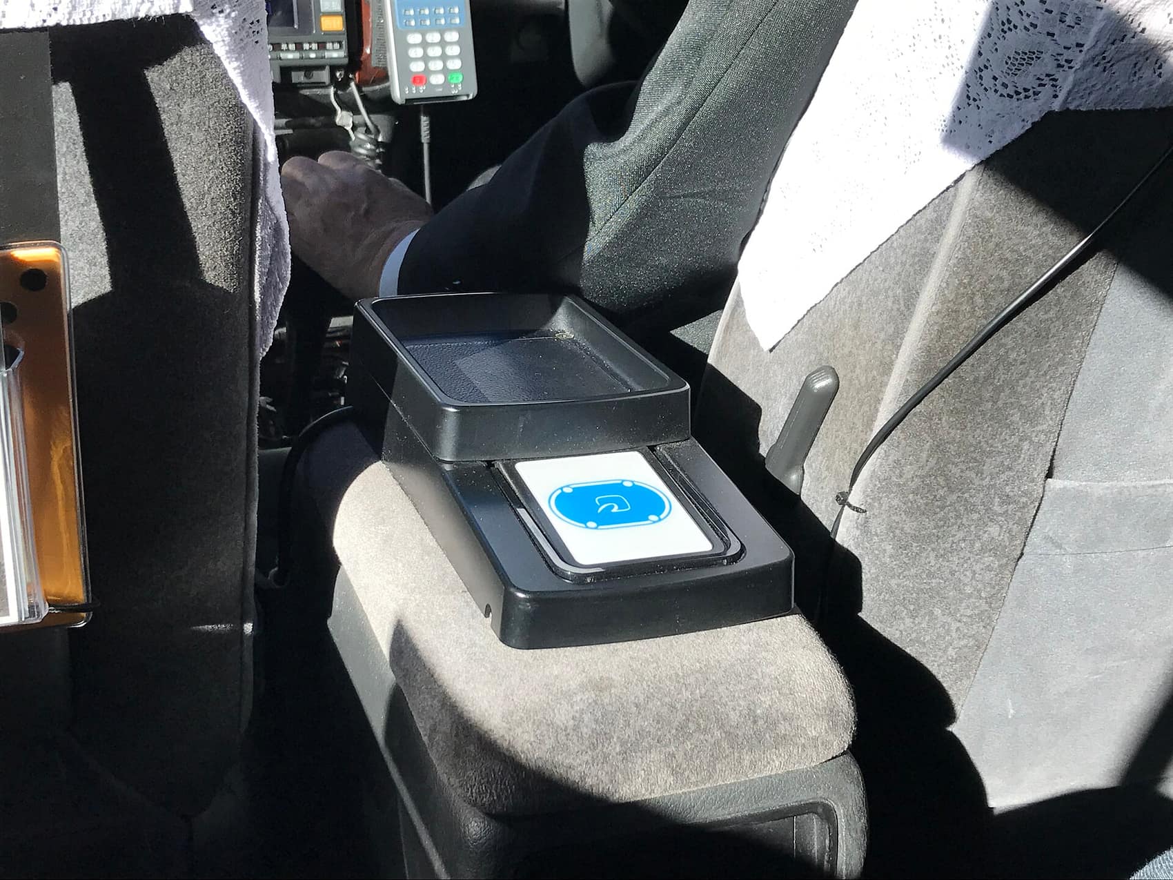 A contactless payment reader inside a Tokyo taxi