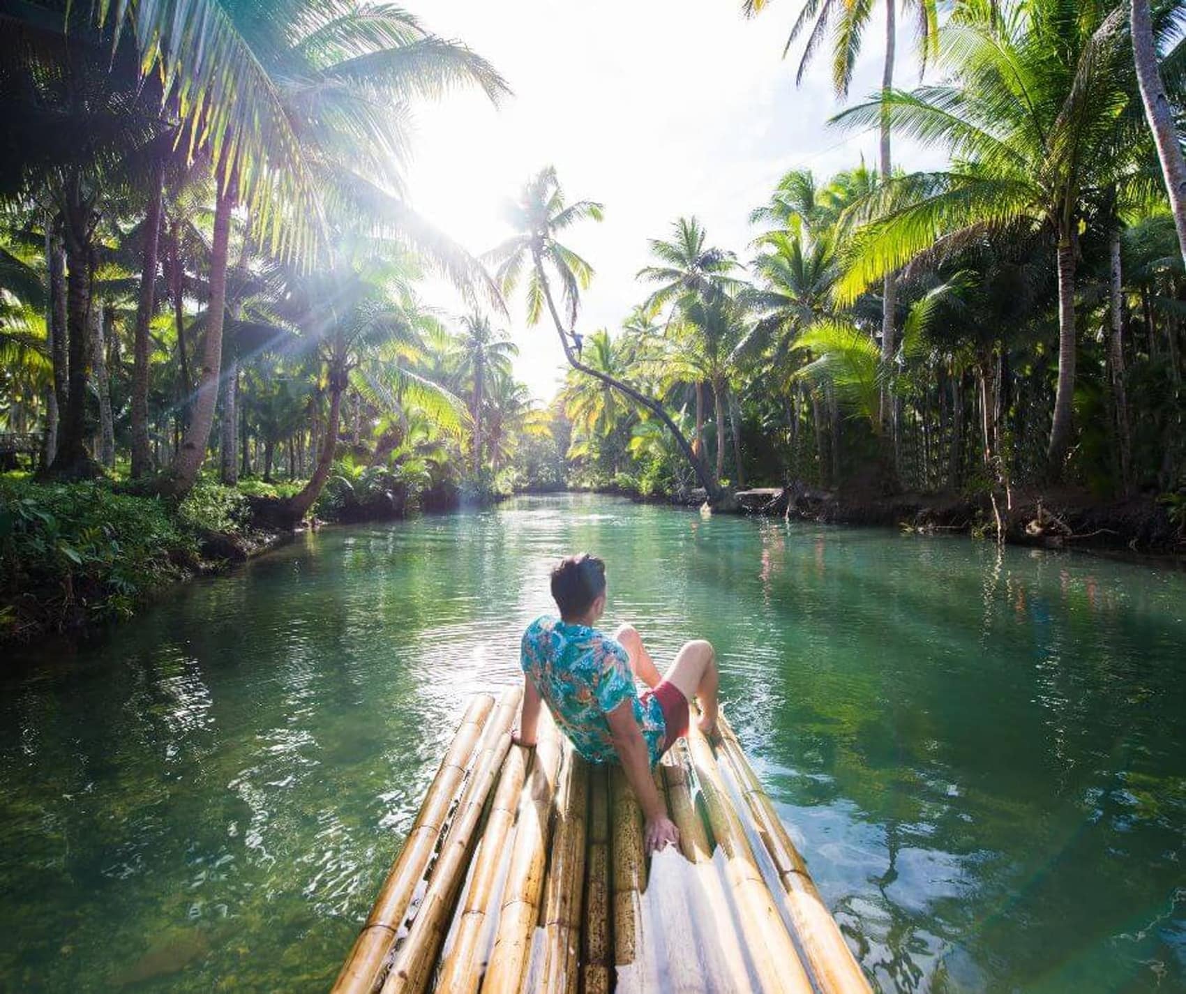 Drifting the Maasin River on a bamboo raft between walls of coconut palm