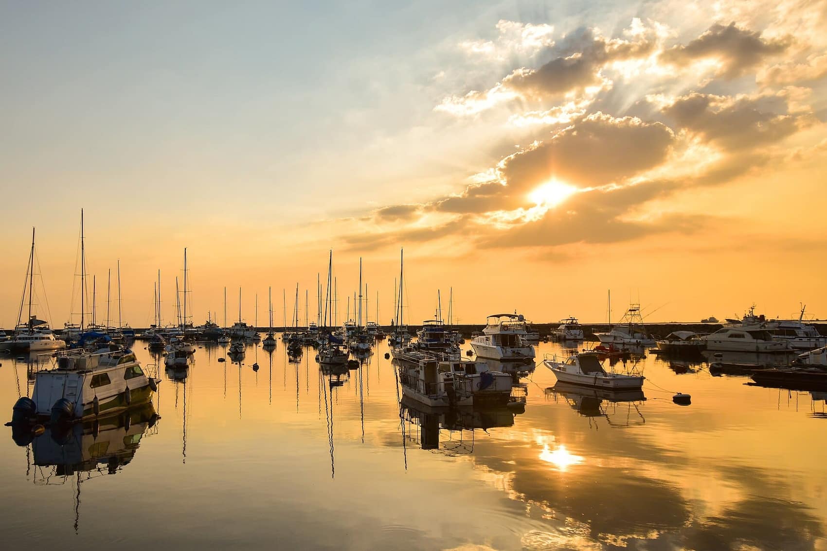 Bangka silhouettes in the gold of a Manila Bay sunset