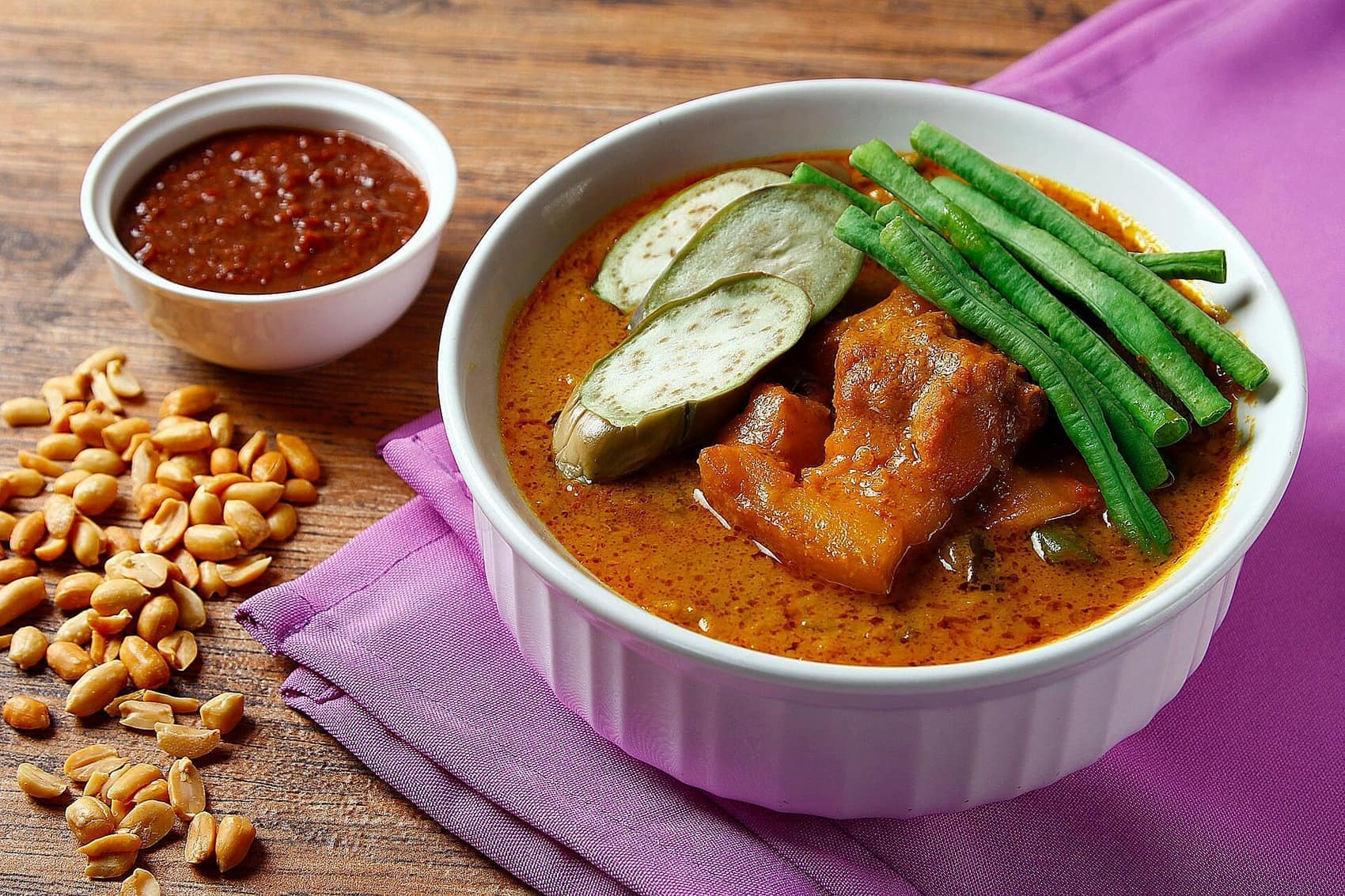 Kare-kare: oxtail and tripe in peanut sauce with banana heart, sitaw and bagoong on the side