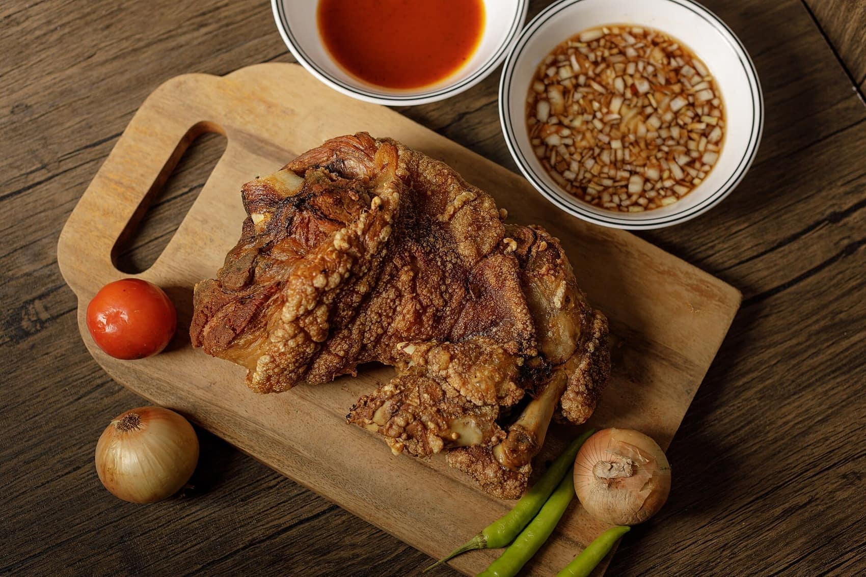 Crispy pata: deep-fried pork knuckle, shattering skin, vinegar dip