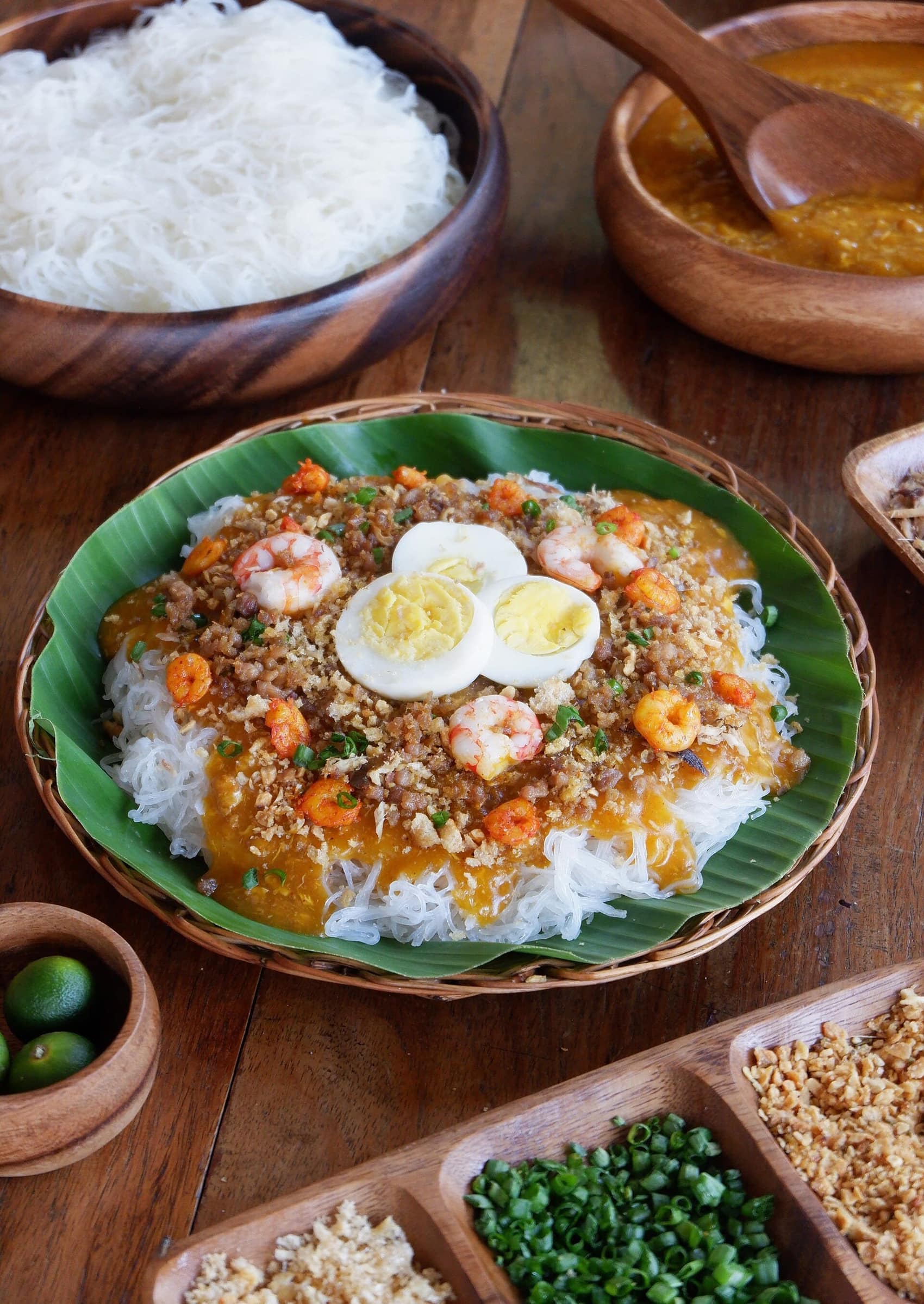 Pancit palabok on banana leaf: shrimp, chicharon, egg and annatto sauce