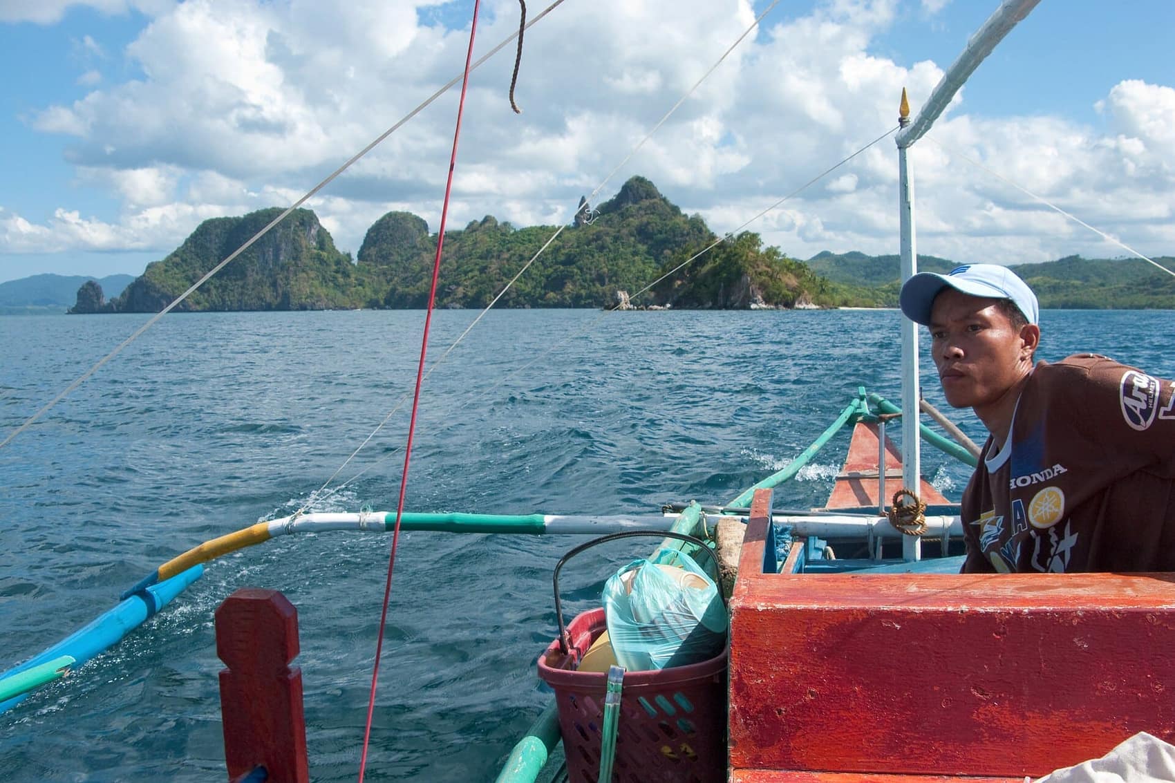 Your captain at the tiller. A charter comes with a boatman and two crew who know which lagoon to hit when