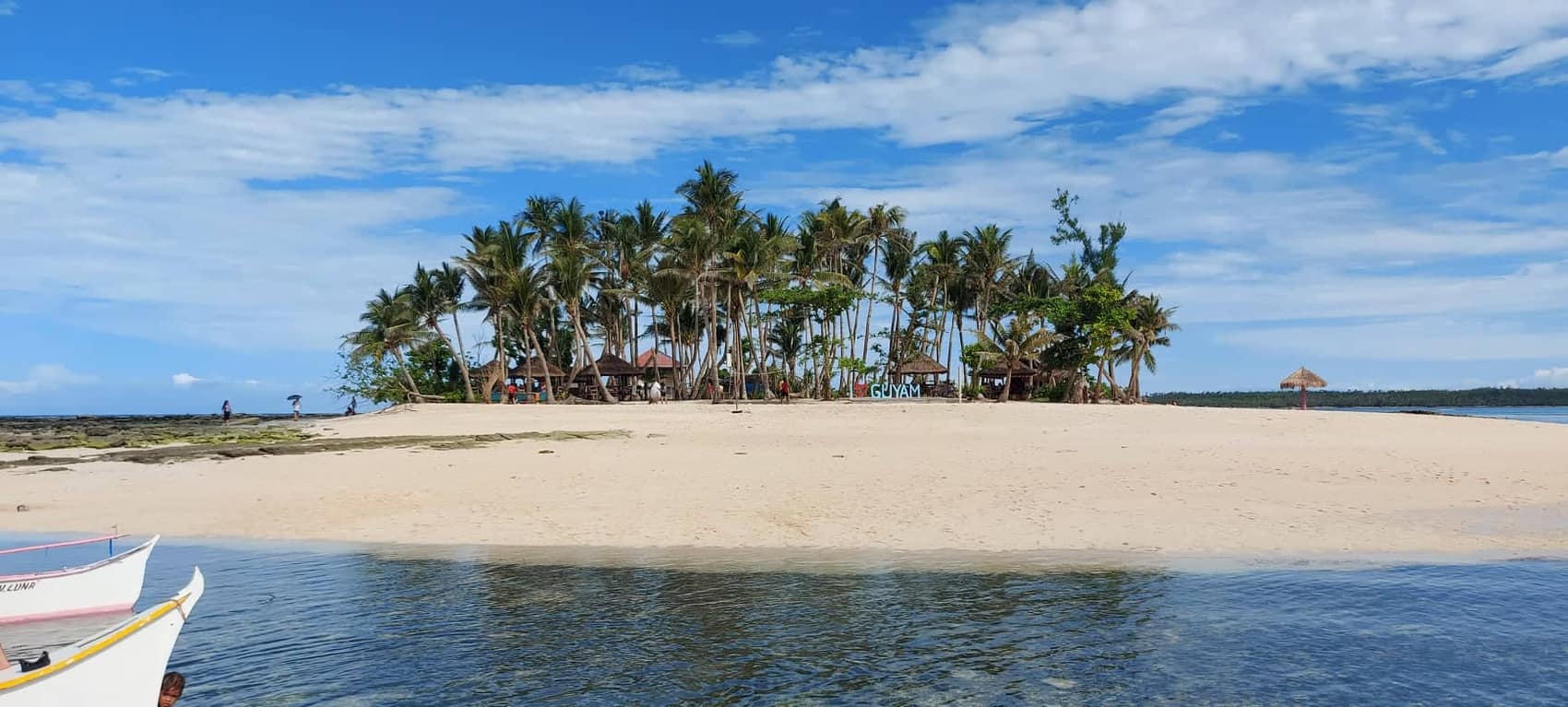 Guyam Island: a sandbar with a crown of palms, first stop on the tri-island run