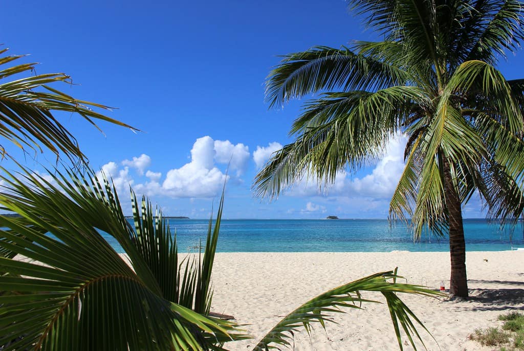 Palm-framed white sand and turquoise shallows on Siargao's southeast coast